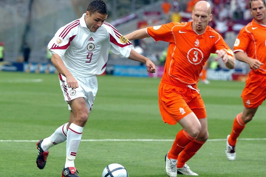 Maris Verpakovskis (Letland) en Jaap Stam (Oranje)